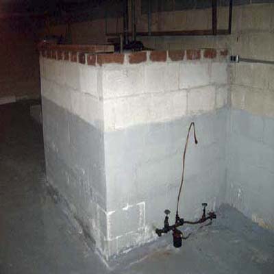 oil tank in front of a leaking wall