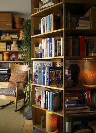 24-foot shelf unit wrapping around bed in studio apartment