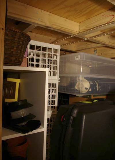 storage area under loft bed in studio apartment