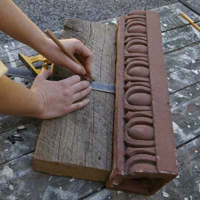 measuring and marking where hooks will go to turn cornice into garden tool holder